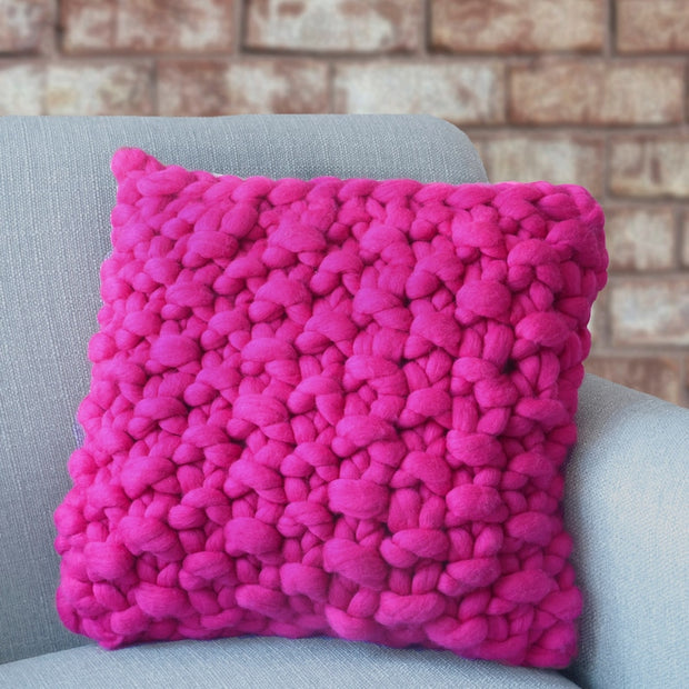 bright pink knitted cushion